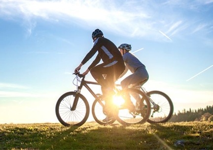 Two people riding bikes